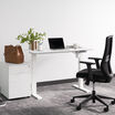 lowered white electric standing split top desk in white